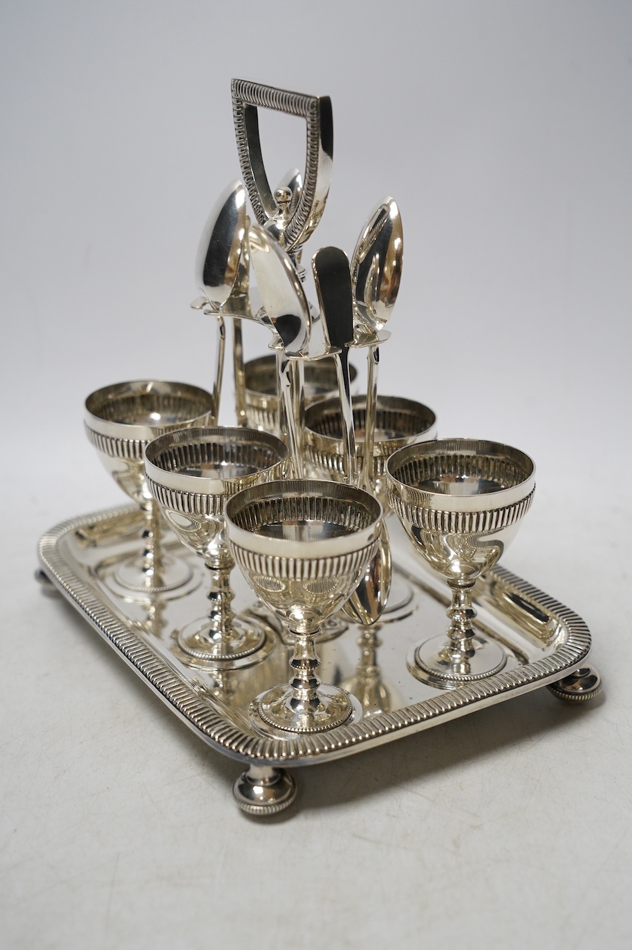 A silver plated six setting egg cruet, 19cm high. Condition - good